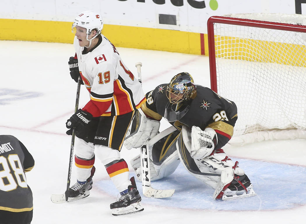 Golden Knights goaltender Marc-Andre Fleury (29) defends the net in front of Calgary Flames left wing Matthew Tkachuk (19) during the third period of an NHL hockey game at T-Mobile Arena in Las Ve ...