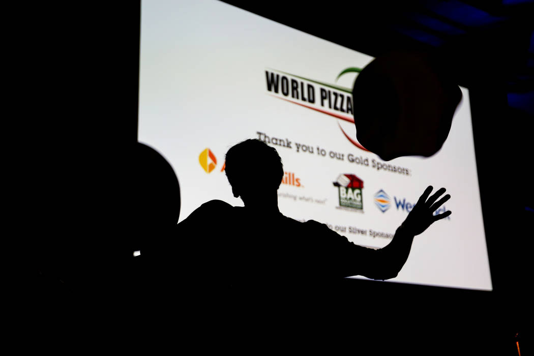 Takumi Tachikawa from Hokkaido, Japan warms up before competing in the dough-tossing championship of the International Pizza Expo at the Las Vegas Convention Center in Las Vegas, Wednesday, March ...