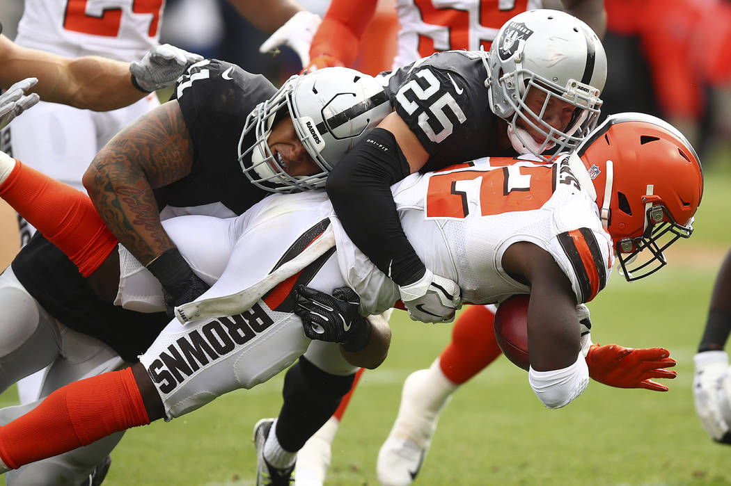 Cleveland Browns' Jabrill Peppers, right, is tackled by Oakland Raiders' Erik Harris (25) and Keith Smith during an NFL football game in Oakland, Calif., Sunday, Sept. 30, 2018. (AP Photo/Ben Margot)