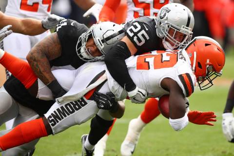Cleveland Browns' Jabrill Peppers, right, is tackled by Oakland Raiders' Erik Harris (25) and Keith Smith during an NFL football game in Oakland, Calif., Sunday, Sept. 30, 2018. (AP Photo/Ben Margot)