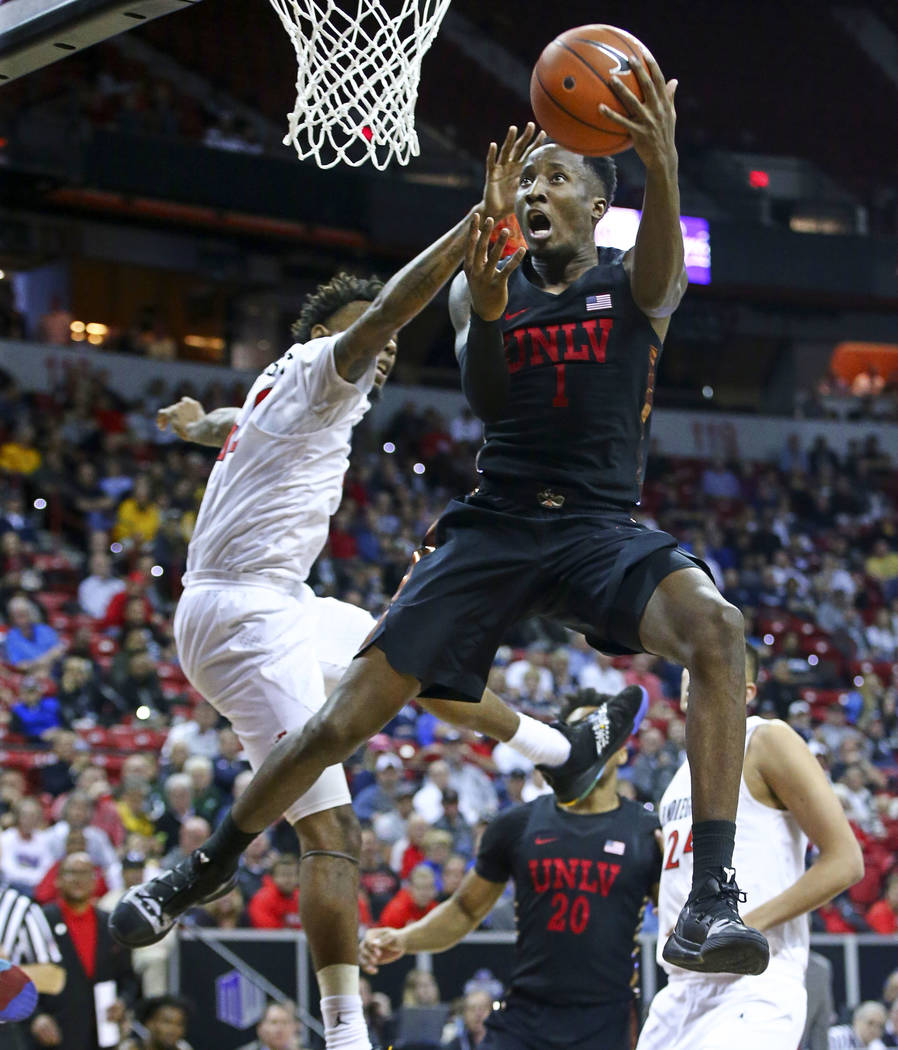 UNLV Rebels guard Kris Clyburn (1) goes to the basket against San Diego State Aztecs guard Jeremy Hemsley during the second half of a quarterfinal game in the Mountain West men's basketball tourna ...