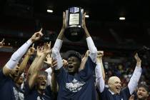 Utah State Aggies center Neemias Queta (23) raises the trophy after their win against San Diego State Aztecs in the Mountain West tournament men's basketball championship game at the Thomas & ...