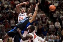 Duke center Marques Bolden (20) is fouled as Virginia Tech's Kerry Blackshear Jr. (24) and Ty Outlaw (42) defend during the first half of an NCAA college basketball game in Blacksburg, Va., Tuesda ...