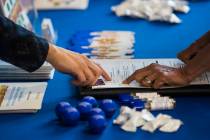 Veronica Arreguin, a personnel analyst with the Clark County School District, left, assists a potential job applicant during a hiring fair held by CCSD at Coronado High School in Henderson on Tues ...
