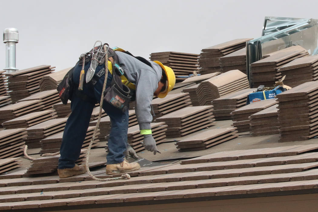 A construction worker installs a new roof during the new construction of LGI Homes at the Intersection of E. Lake Mead Boulevard and Dolly Lane photographed on Friday, March. 8, 2019, in Las Vegas ...