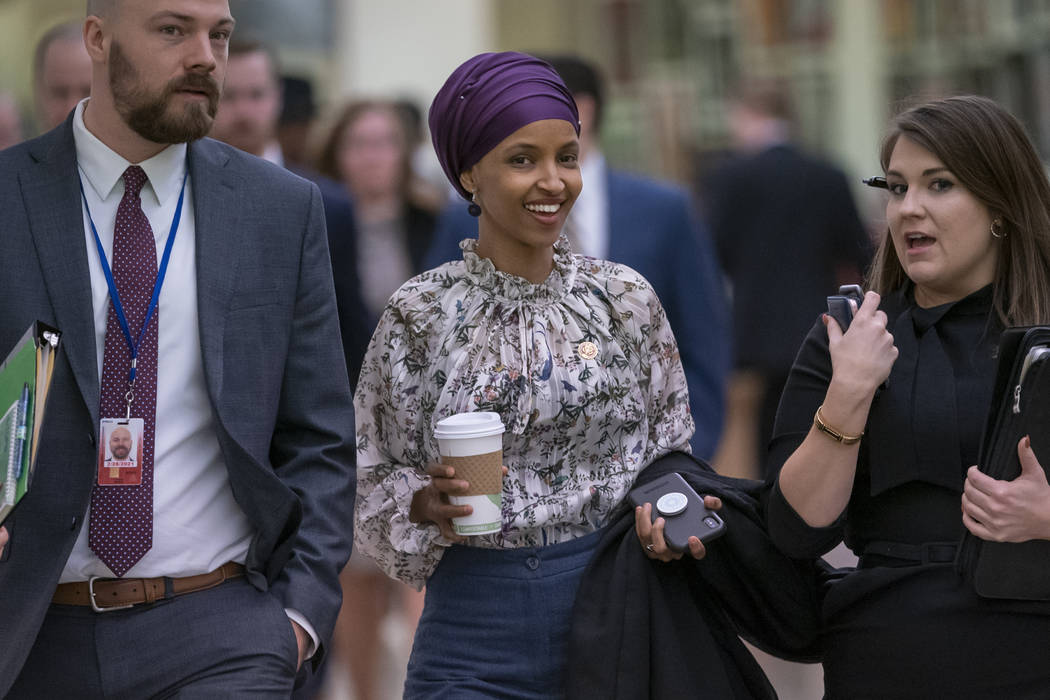 Rep. Ilhan Omar, D-Minn., walks through an underground tunnel at the Capitol as top House Democrats plan to offer a measure that condemns anti-Semitism in the wake of controversial remarks by the ...