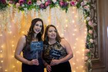 Stephanie Coronado, left, poses in a photo booth with her mother-in-law Anita Coronado, right, at a fundraising gala for Living Grace Homes, an organization that helps homeless women and children, ...