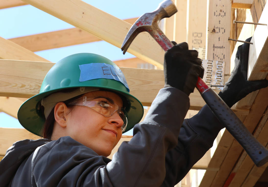 Ellie Lukova of the Las Vegas Aces hammers a nail as she volunteers to help with the construction of Habitat for Humanity Las Vegas’ 112th home in celebration of International Women’s Day on F ...
