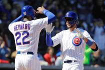 Chicago Cubs' Kris Bryant, right, celebrates with Jason Heyward after hitting a two-run home run during the first inning of a spring training baseball game against the Milwaukee Brewers, Saturday, ...