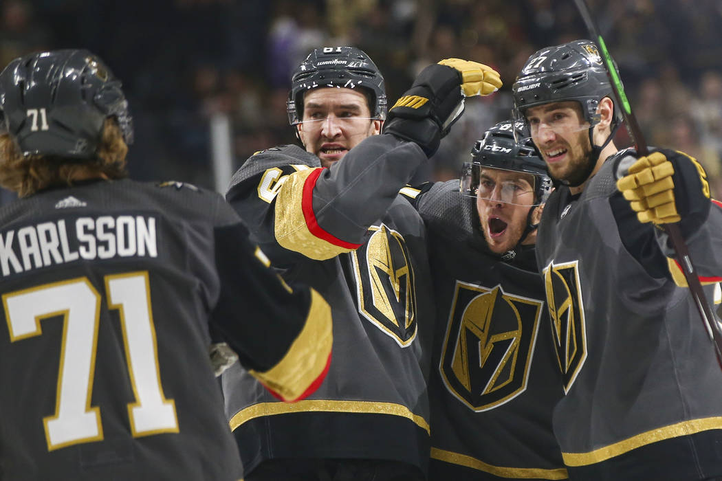 Golden Knights right wing Mark Stone, second from left, celebrates the goal scored by defenseman Shea Theodore, right, with their teammates center William Karlsson (71) and center Jonathan March ...