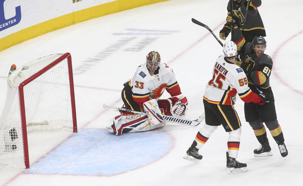 Golden Knights center Jonathan Marchessault (81) celebrates a goal by defenseman Deryk Engelland, not pictured, as Calgary Flames goaltender David Rittich (33) and defenseman Noah Hanifin (55) rea ...