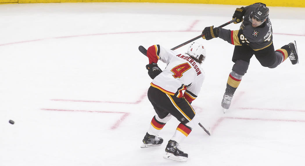 Golden Knights left wing Max Pacioretty (67) shoots the puck past Calgary Flames defenseman Rasmus Andersson (4) during the third period of an NHL hockey game at T-Mobile Arena in Las Vegas on Wed ...