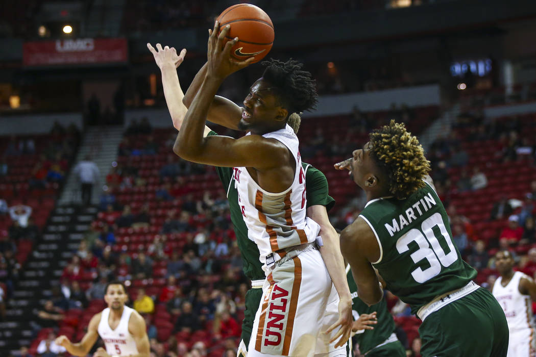 UNLV Rebels forward Joel Ntambwe (24) gets a rebound in front of Colorado State guard Kris Martin (30) during the second half of a basketball game at the Thomas & Mack Center in Las Vegas on W ...