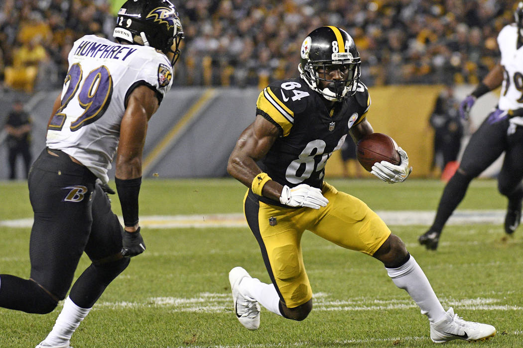 Pittsburgh Steelers wide receiver Antonio Brown (84) runs after taking a pass from quarterback Ben Roethlisberger during the first half of an NFL football game with Baltimore Ravens cornerback Mar ...