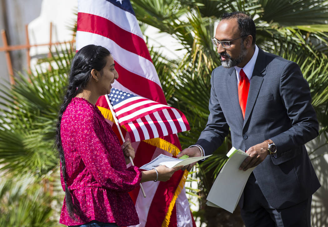 Mandeep Kaur of Bakersfield, Calif., receives her naturalization certificate from Gurinder Johal, of the U.S. Citizenship and Immigration Services field office in Fresno, Calif., during a naturali ...