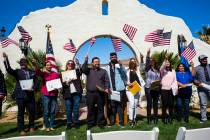 Attendees including Mandeep Kaur of Bakersfield, Calif., second from the left, and Raul Vargas, originally from Guatemala, the fourth from the left, pose for photographs while waving their flags a ...