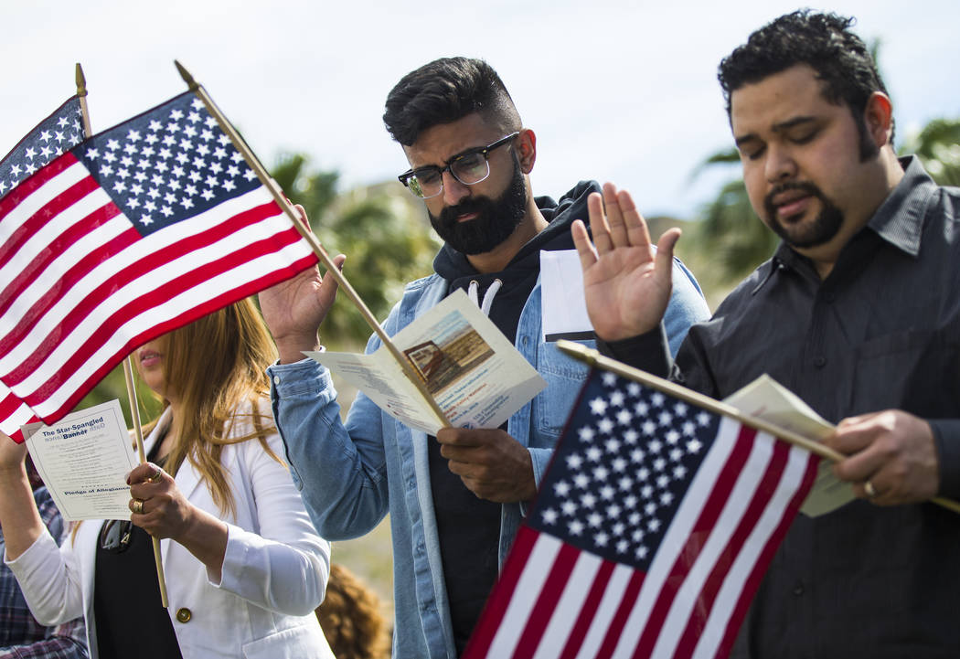 Mandeep Sidha, of Los Angeles, who immigrated from India, recites the oath of allegiance during a naturalization ceremony at the Mission Gardens at The Inn at Death Valley in Death Valley National ...