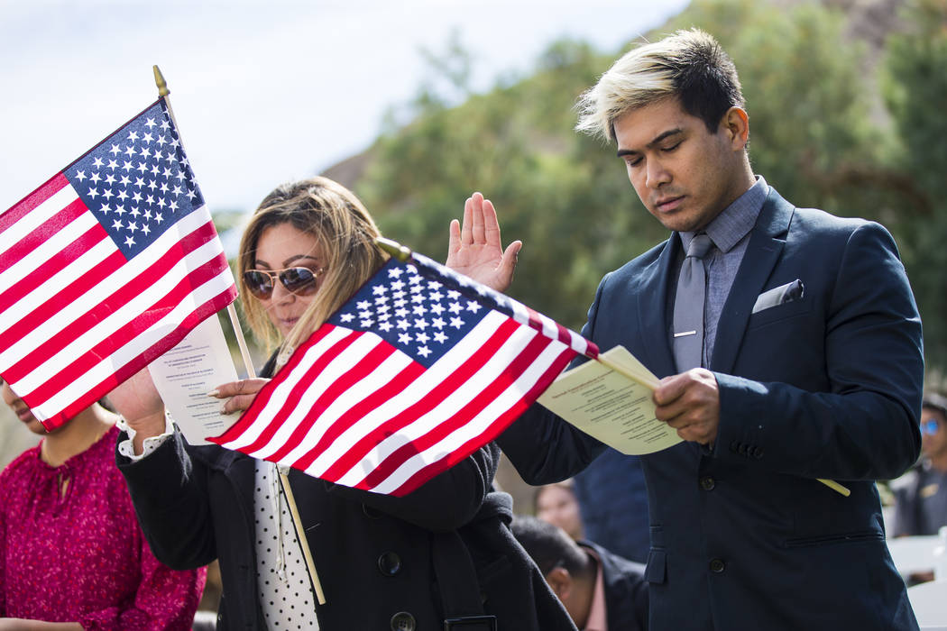 Marti Reyes, of Big Pine, Calif., originally from Phillipines, recites the pledge of allegiance during a naturalization ceremony at the Mission Gardens at The Inn at Death Valley in Death Valley N ...