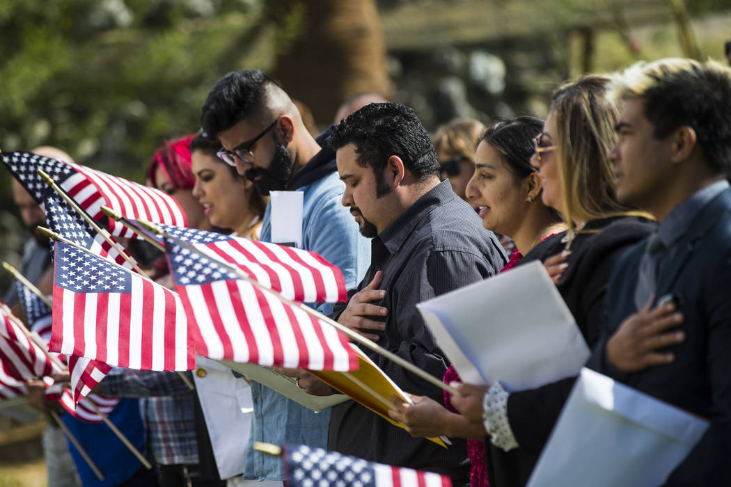 Raul Vargas, originally from Guatemala, recites the national anthem during a naturalization ceremony at the Mission Gardens at The Inn at Death Valley in Death Valley National Park, Calif., on Fri ...