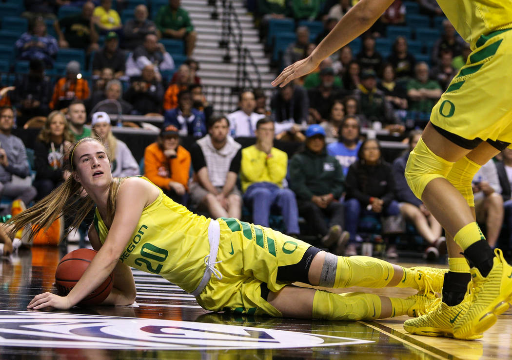 Oregon Ducks guard Sabrina Ionescu (20) falls down wit the ball during the second half of an NCAA college basketball game at the Pac-12 women's tournament at the MGM Grand Garden Arena in Las Vega ...