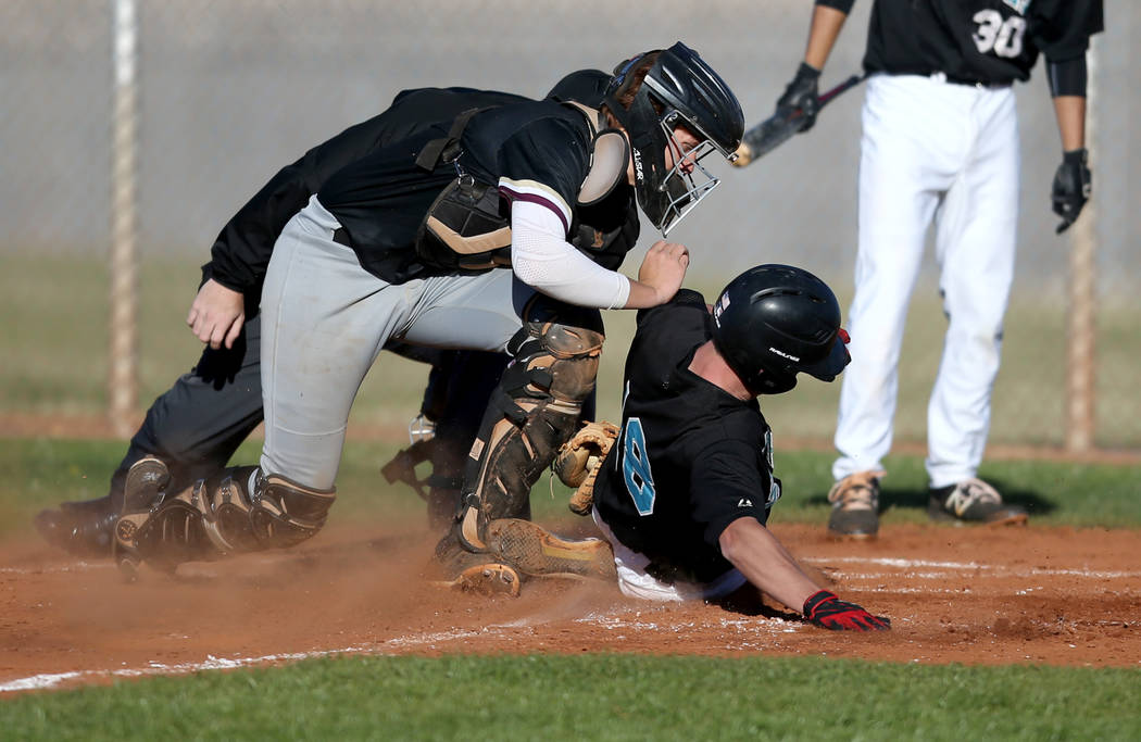 Faith Lutheran catcher Carson Bonus (6) tags out Silverado baserunner Brant Hunt (18) at home during a baseball game at Silverado High School in Las Vegas Friday, March 8, 2019. (K.M. Cannon/Las V ...