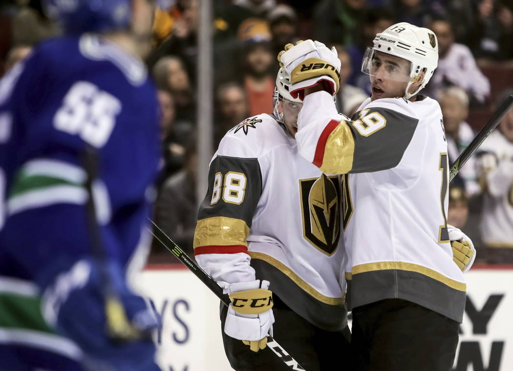 Vegas Golden Knights' Nate Schmidt (88) celebrates his goal with teammate Reilly Smith (19) during the second period of an NHL hockey game in Vancouver, British Columbia, Saturday, March 9, 2019. ...