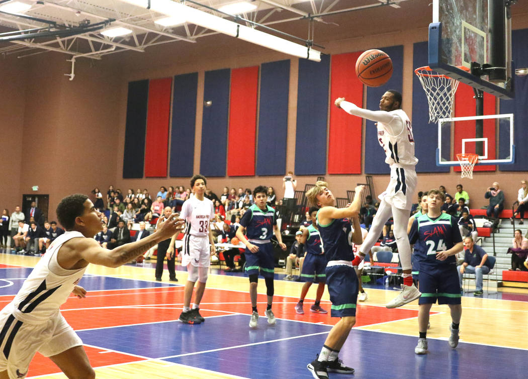 Darren Jones (52) swats away a shot made by a SLAM Academy player during a varsity basketball game at American Preparatory Academy in Las Vegas, Thursday, Jan. 17, 2019. (Heidi Fang /Las Vegas Rev ...