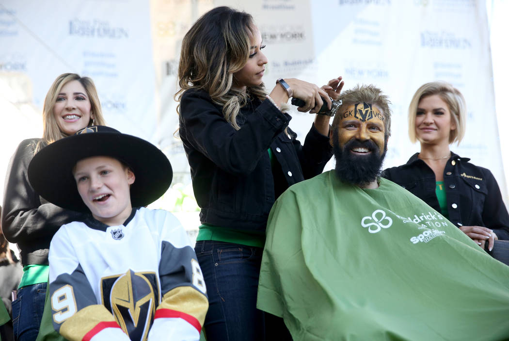 John McManus of Las Vegas gets his head shaved by Ashton of the show Fantasy during St. Baldrick's Foundation shave-a-thon on the Brooklyn Bridge at New York-New York in Las Vegas, Saturday, March ...