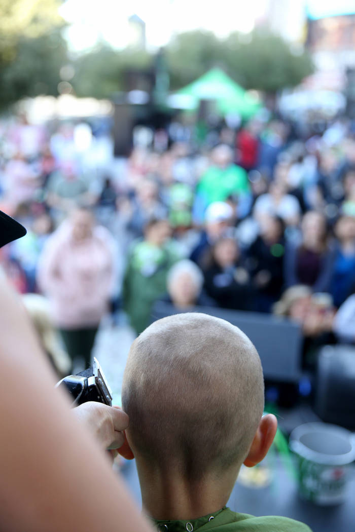 Dylan Foote, 8, of Las Vegas gets his head shaved during St. Baldrick's Foundation shave-a-thon on the Brooklyn Bridge at New York-New York in Las Vegas, Saturday, March 9, 2019. (K.M. Cannon/Las ...