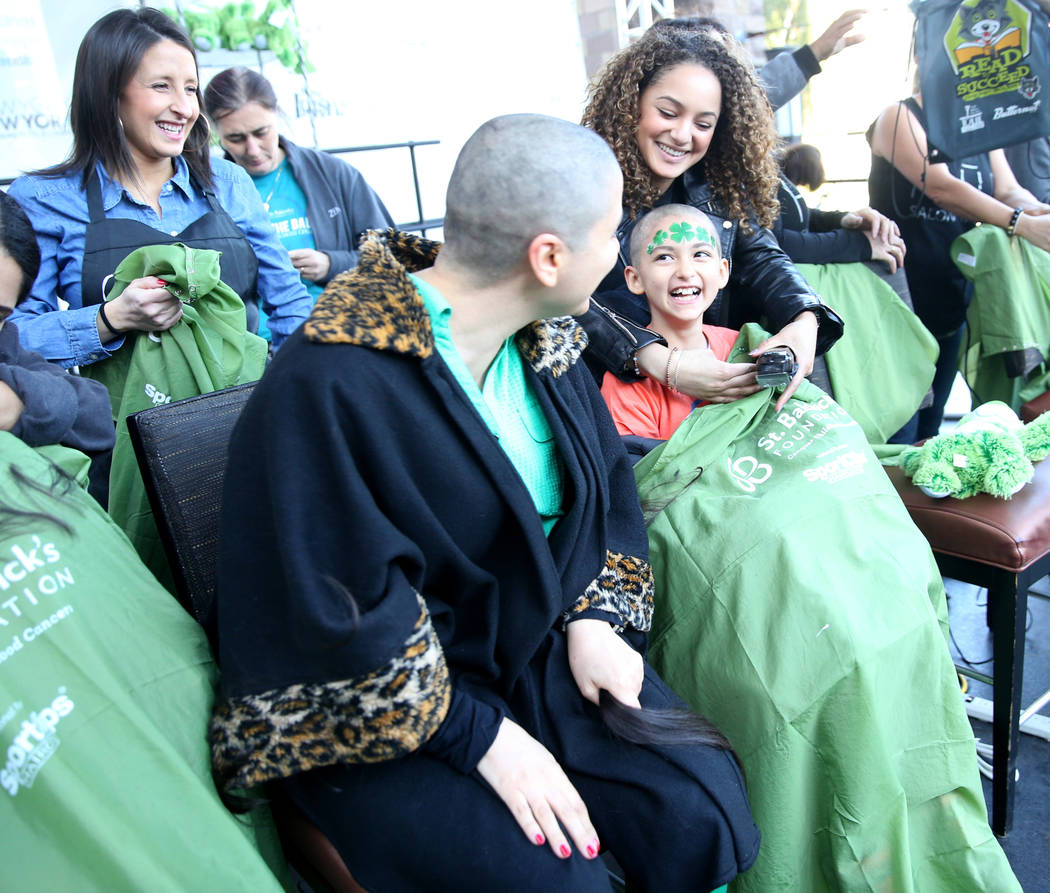 Katrin Ivanoff, 9, of Las Vegas, reacts to her mother, also Katrin Ivanoff, after getting their heads shaved during St. Baldrick's Foundation shave-a-thon on the Brooklyn Bridge at New York-New Yo ...