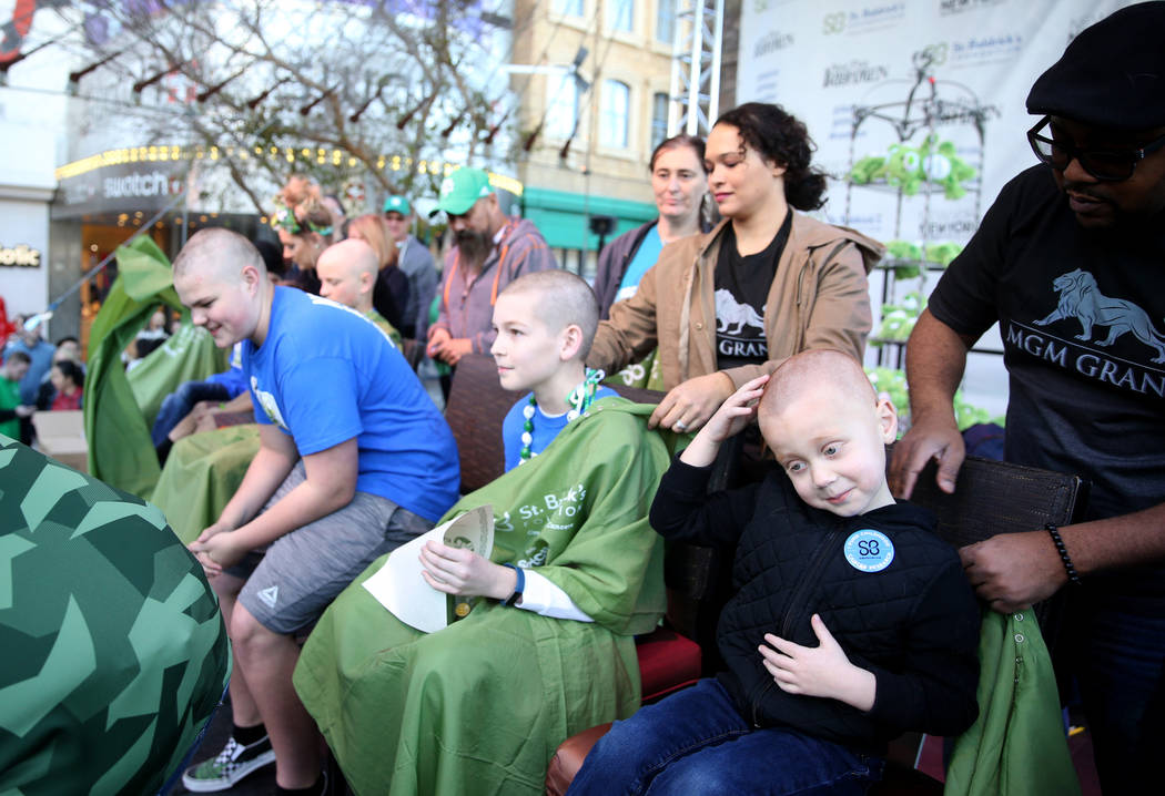 Preston Fitch, 4, of Las Vegas, reacts after getting his head shaved by MGM barber Anthony Banks during St. Baldrick's Foundation shave-a-thon on the Brooklyn Bridge at New York-New York in Las Ve ...