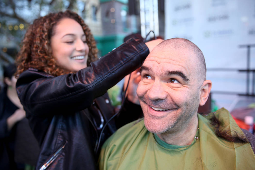 Las Vegas Review-Journal man-about-town columnist John Katsilometes gets his head shaved by Brianna Brown during St. Baldrick's Foundation shave-a-thon on the Brooklyn Bridge at New York-New York ...