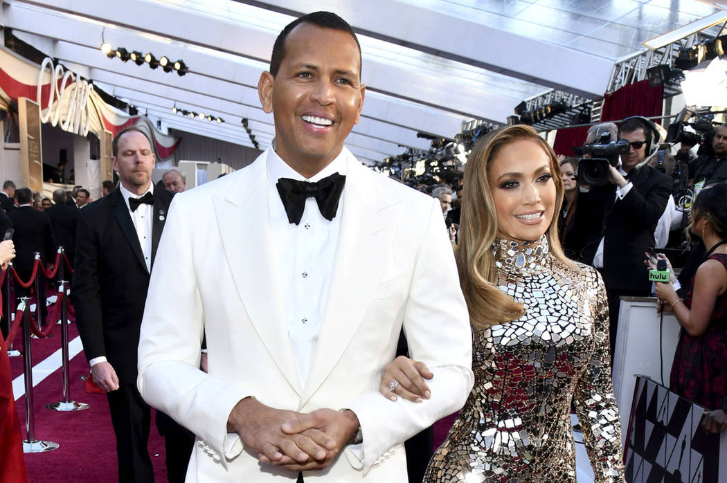 Alex Rodriguez, left, and Jennifer Lopez arrive at the Oscars at the Dolby Theatre in Los Angeles in February 2019. (Photo by Charles Sykes/Invision/AP)