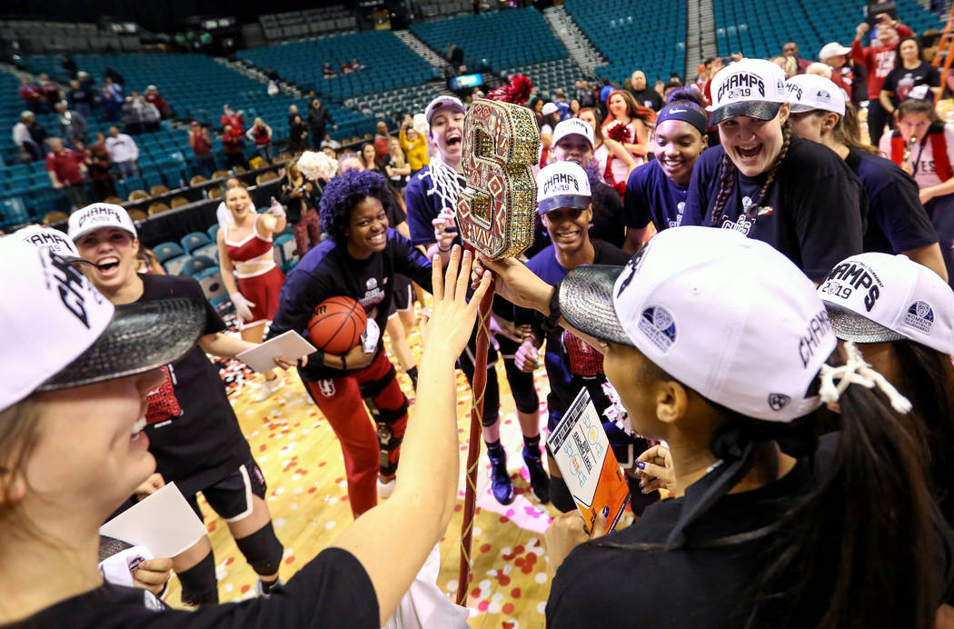 The Stanford Cardinals celebrate after defeating the Oregon Ducks during a NCAA college basketball game in the final of the Pac-12 women's tournament at the MGM Grand Garden Arena in Las Vegas, Su ...