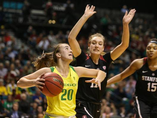 Oregon Ducks guard Sabrina Ionescu (20) drives past Stanford Cardinal forward Alanna Smith (11) and Stanford Cardinal forward Maya Dodson (15) during the second half of an NCAA college basketball ...