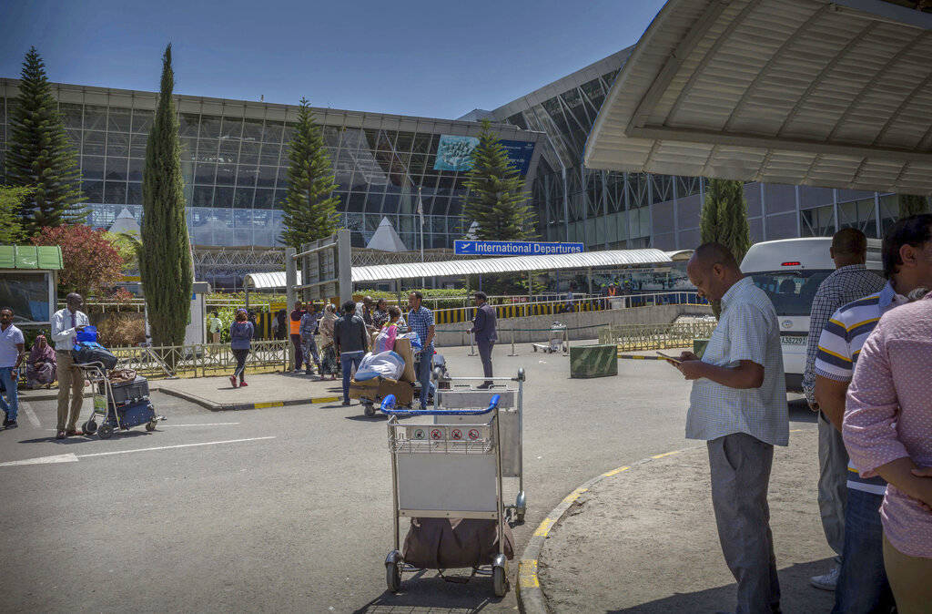 Passengers wait outside the Bole International airport Addis Ababa, Ethiopia, Sunday, March 10, 2019. An Ethiopian Airlines flight crashed shortly after takeoff from Ethiopia's capital on Sunday m ...