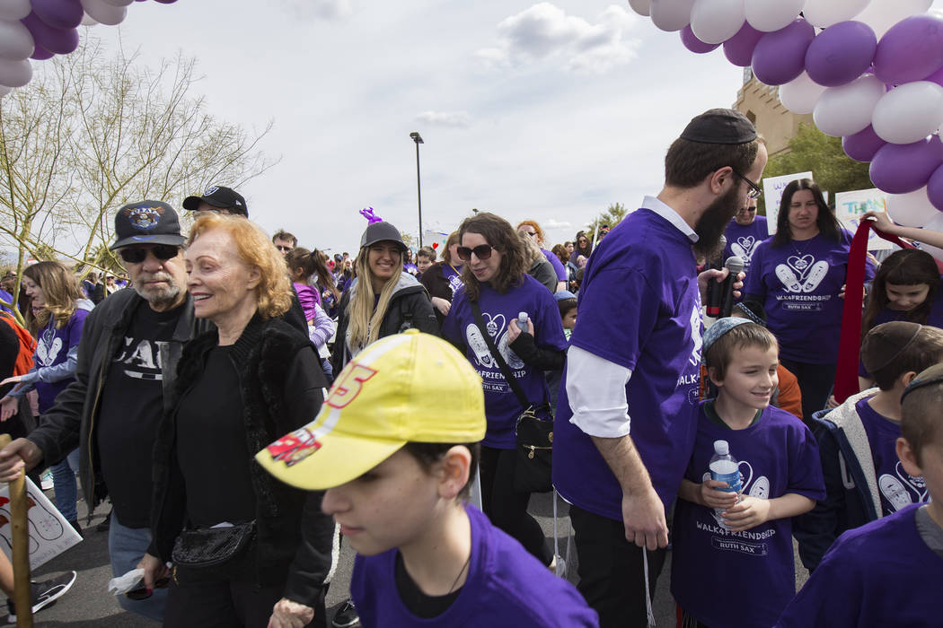 A crowd walks through ribbon from Bet Yossef Community Center to Las Vegas Sports Park during Friendship Circle's Walk4Friendship Las Vegas event in Las Vegas, Sunday, March 10 ...