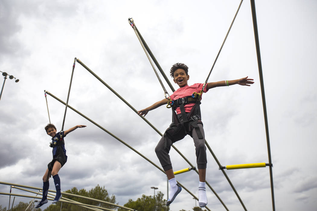 Kaj Freeborn, 9, left, and his brother Travis Williams, 10, on a jumping ride during Friendship Circle's Walk4Friendship Las Vegas event at Las Vegas Sports Park, Sunday, March 10, ...