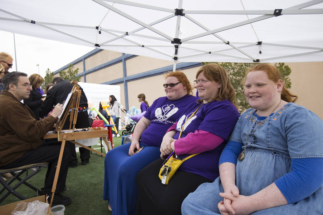Shaina Kinn, from left, her mother Shoshana Kinn, and her sister Goldie Kinn, 13, have their caricature done at Friendship Circle's Walk4Friendship Las Vegas event at Las Vegas ...