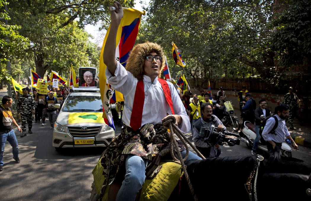 A horse mounted exile Tibetan shouts slogans during a march to mark the 60th anniversary of the March 10, 1959 Tibetan Uprising Day, in New Delhi, India, Sunday, March 10, 2019. The uprising of th ...