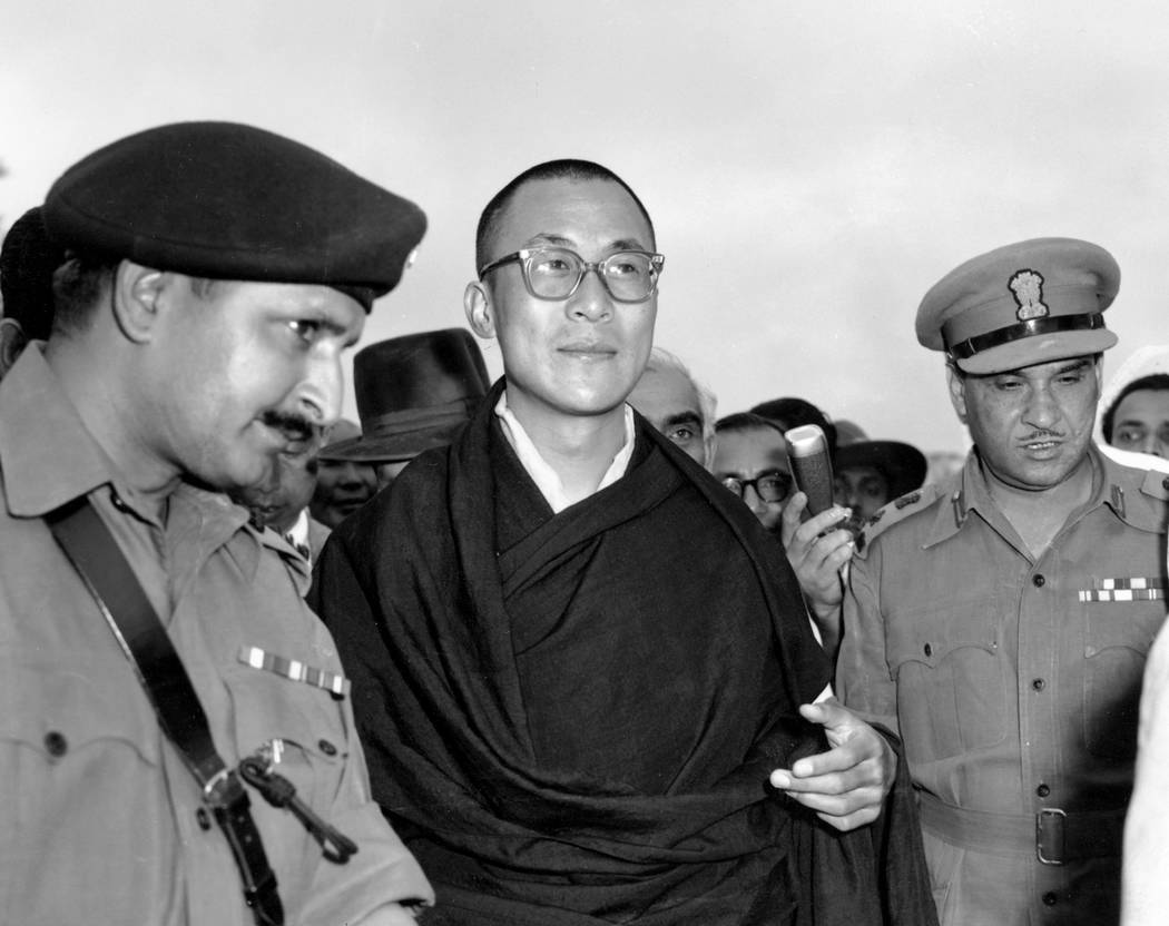 FILE - In this April 18, 1959, file photo, Tibetan spiritual leader the Dalai Lama, center, arrives at Tezpur, Assam in India. Tibetan activists put up posters and hoisted a Tibetan flag in Indi ...