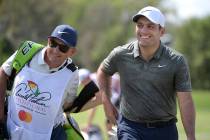 Francesco Molinari, right, of Italy, leaves the first green after making a putt for birdie during the final round of the Arnold Palmer Invitational golf tournament Sunday, March 10, 2019, in Orlan ...