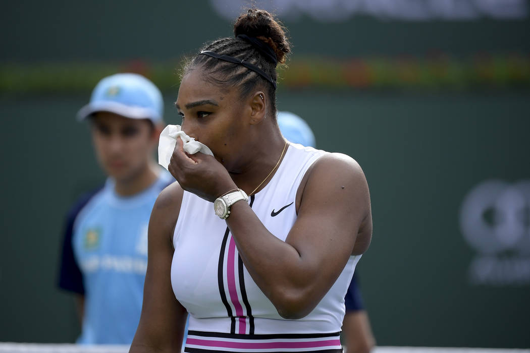 Serena Williams leaves the court, retiring with a medical issue, during her match against Garbine Muguruza, of Spain, at the BNP Paribas Open tennis tournament Sunday, March 10, 2019, in Indian We ...