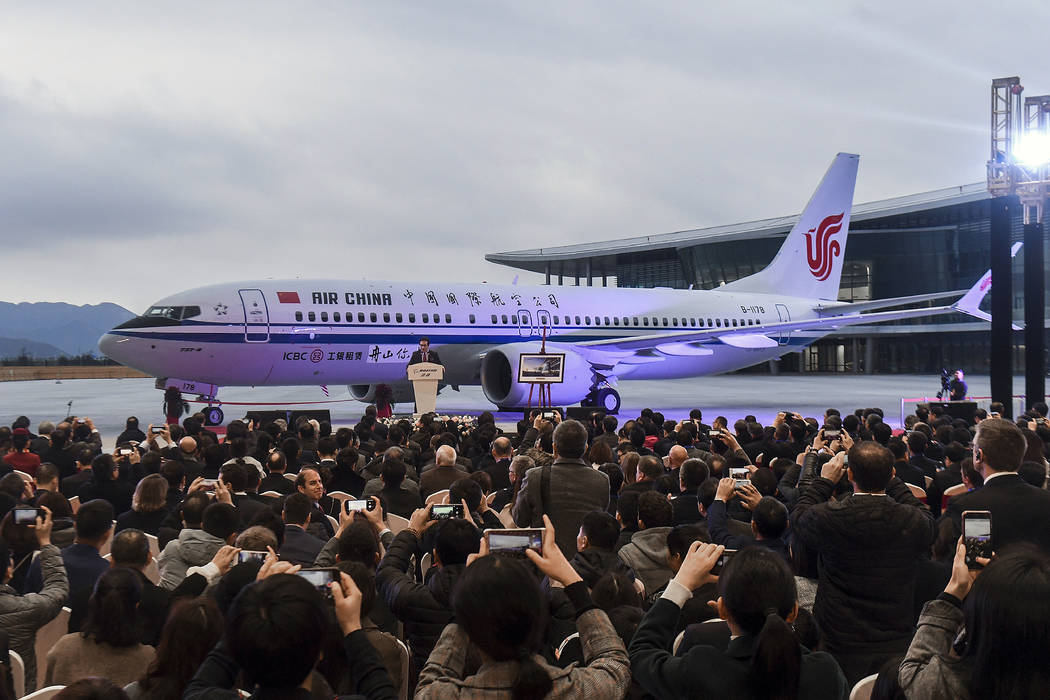 Invited guests take photos of the Boeing 737 Max 8 airplane deliver to Air China during a ceremony at Boeing Zhoushan 737 Completion and Delivery Center in Zhoushan, east China's Zhejiang Province ...