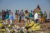Workers gather at the scene of an Ethiopian Airlines flight crash near Bishoftu, or Debre Zeit, south of Addis Ababa, Ethiopia, Monday, March 11, 2019. A spokesman says Ethiopian Airlines has gro ...
