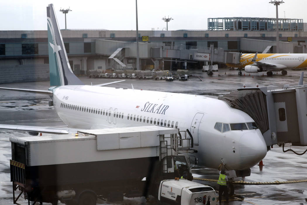 SilkAir's new Boeing 737 Max 8 aircraft is seen through a viewing gallery window parked on the tarmac of Singapore's Changi International Airport, Oct. 4, 2017. China's civilian aviation authority ...