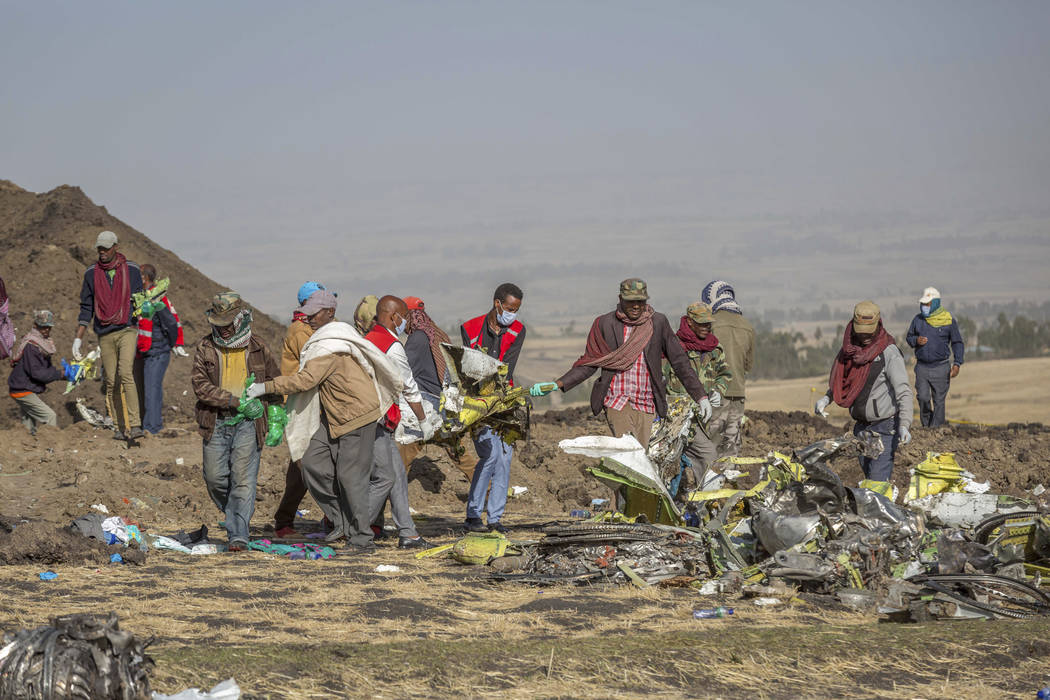 Rescuers work at the scene of an Ethiopian Airlines flight crash near Bishoftu, or Debre Zeit, south of Addis Ababa, Ethiopia, Monday, March 11, 2019. A spokesman says Ethiopian Airlines has grou ...