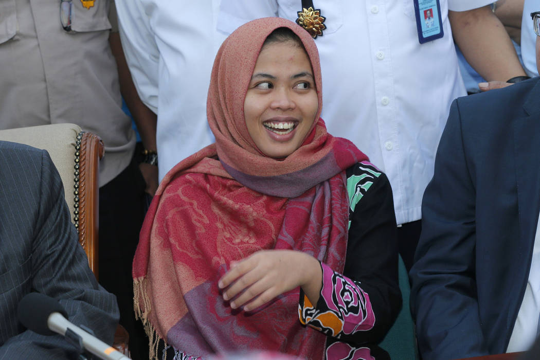 Indonesian Siti Aisyah smiles during a press conference upon returning home from Malaysia at Halim Perdanakusumah Airport in Jakarta, Indonesia, Monday, March 11, 2019. The Indonesian woman held t ...