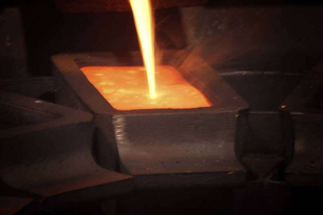 A gold pour at Barrick Gold Corp. Pipeline refinery, located about 70 miles southwest of Elko. Barrick Gold is dropping its takeover bid for Newmont Mining, as the gold companies instead form a jo ...