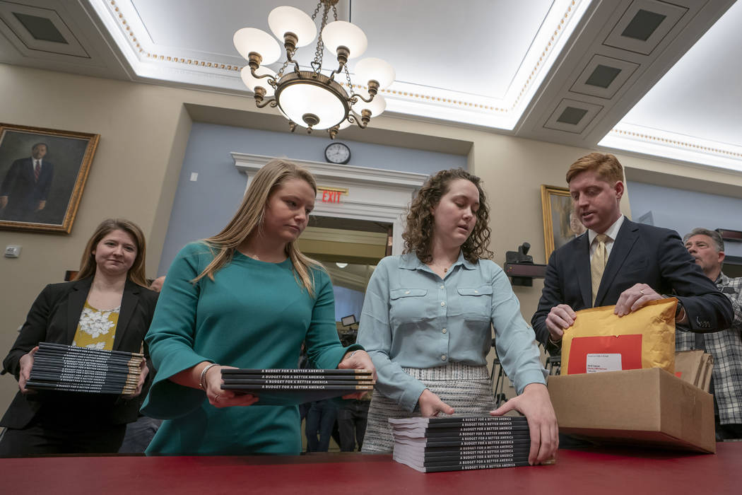 Office of Management and Budget staff delivers President Donald Trump's 2020 budget to the House Budget Committee on Capitol Hill in Washington, Monday, March 11, 2019. (J. Scott Applewhite/AP)